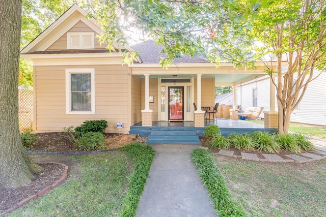 view of front of home with covered porch and roof with shingles