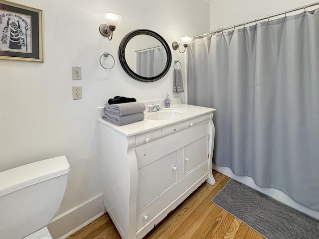 full bath featuring toilet, wood finished floors, vanity, baseboards, and a shower with curtain