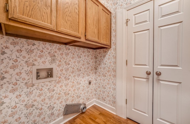 laundry area featuring wallpapered walls, cabinet space, baseboards, light wood-style flooring, and washer hookup