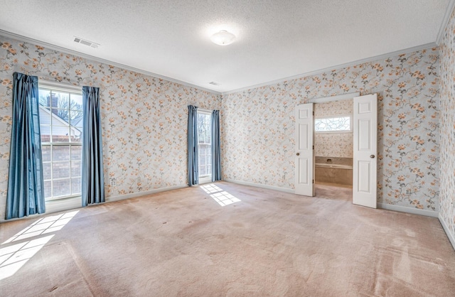 unfurnished room featuring carpet floors, visible vents, a textured ceiling, and wallpapered walls