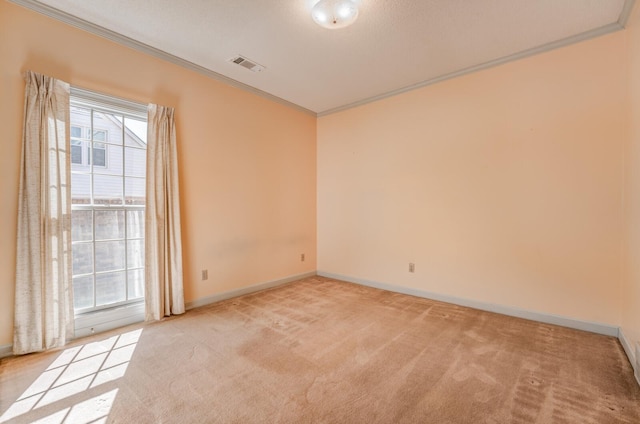 unfurnished room featuring baseboards, visible vents, light colored carpet, and ornamental molding