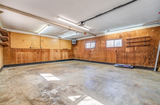 garage featuring wooden walls and a garage door opener