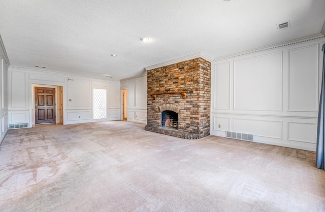 unfurnished living room with light carpet, visible vents, and a decorative wall