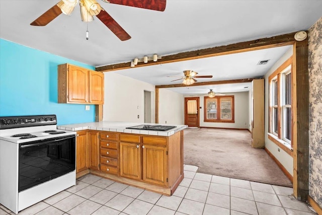 kitchen featuring a peninsula, light tile patterned floors, black stovetop, and white range with electric cooktop