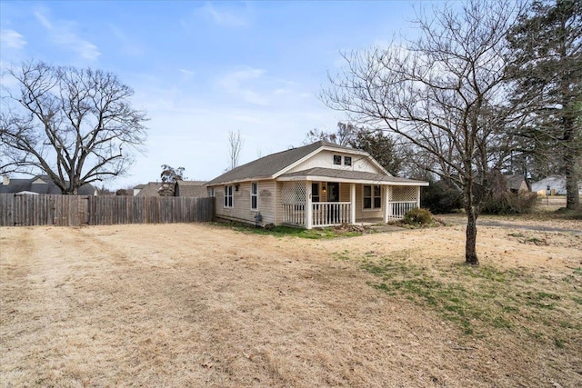 bungalow with covered porch and fence