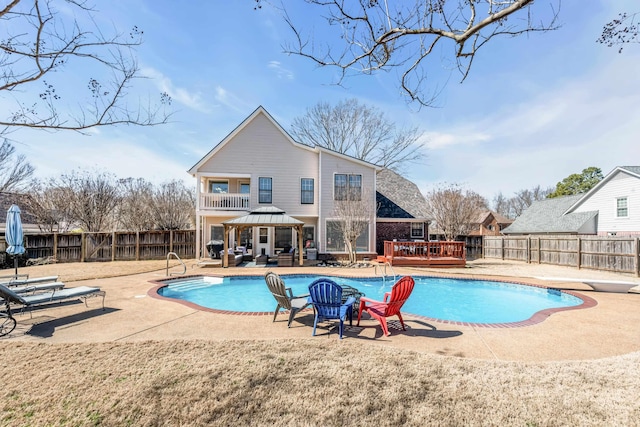 view of pool with a diving board, a gazebo, a fenced backyard, and a fenced in pool