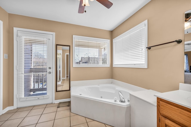 full bathroom featuring a ceiling fan, vanity, a tub with jets, and tile patterned floors