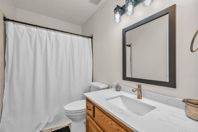 bathroom with visible vents, toilet, a shower with curtain, a textured ceiling, and vanity