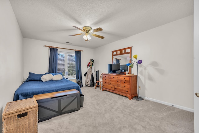 bedroom with a textured ceiling, carpet, visible vents, and baseboards