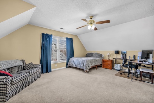 bedroom with visible vents, vaulted ceiling, a textured ceiling, and carpet flooring