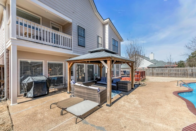 view of patio / terrace featuring a fenced in pool, a gazebo, an outdoor hangout area, a grill, and a fenced backyard