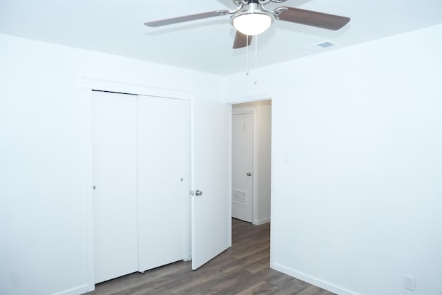 unfurnished bedroom with a ceiling fan, a closet, visible vents, and wood finished floors