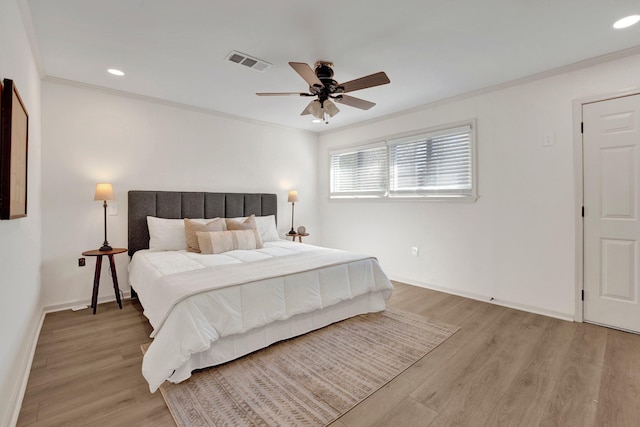 bedroom featuring crown molding, recessed lighting, visible vents, light wood-style flooring, and baseboards