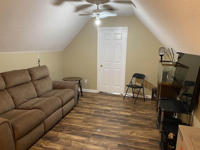 living room featuring a textured ceiling, ceiling fan, lofted ceiling, dark wood-style flooring, and baseboards