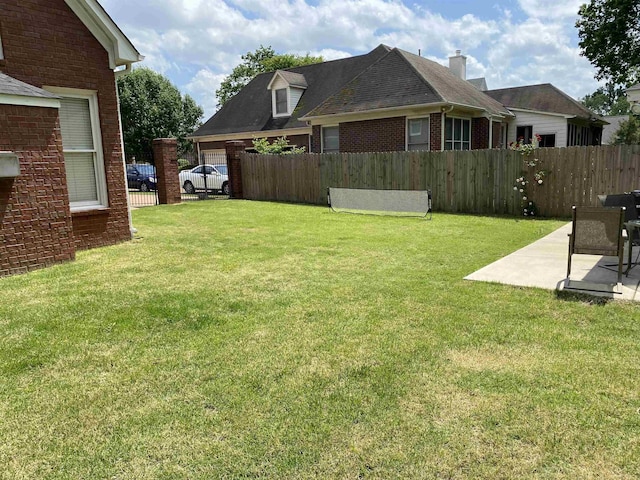 view of yard featuring fence and a patio