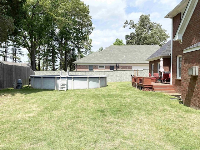 view of yard featuring a fenced in pool, fence, and a wooden deck