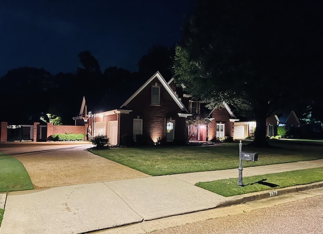 view of front of house with a garage, driveway, and a lawn