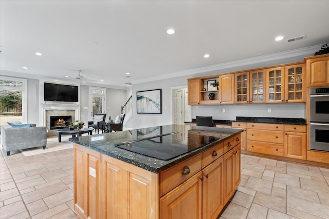 kitchen with visible vents, a lit fireplace, black electric stovetop, double oven, and recessed lighting