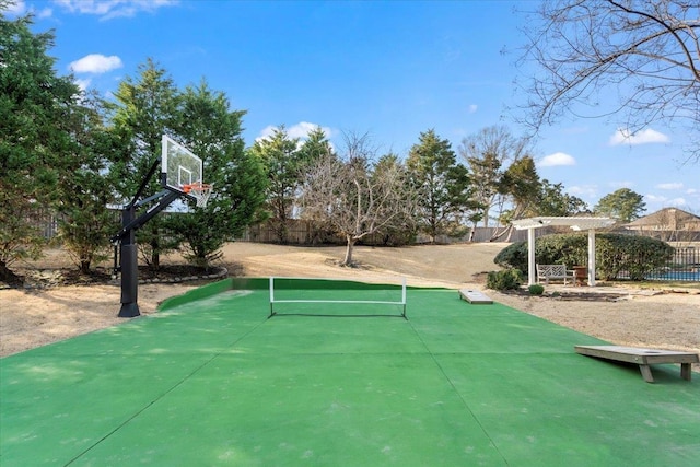 view of basketball court with community basketball court and fence