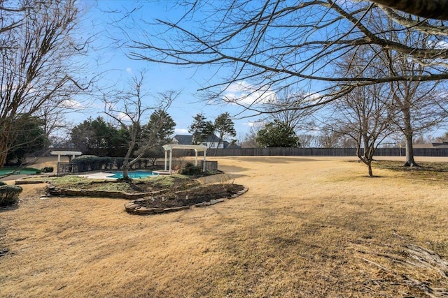 view of yard with fence and a fenced in pool