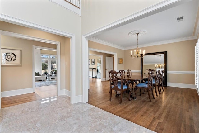 dining area with visible vents, wood finished floors, a notable chandelier, and ornamental molding