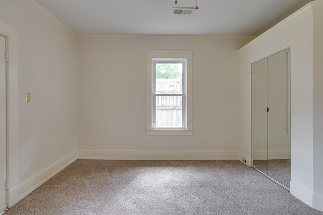 unfurnished bedroom featuring a closet, carpet, visible vents, and baseboards