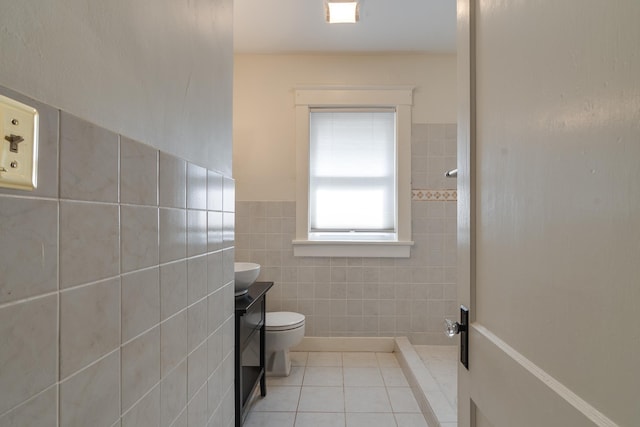 full bath with a shower, tile walls, toilet, vanity, and tile patterned floors