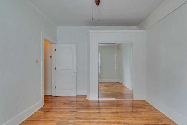 spare room with ornamental molding, baseboards, and wood finished floors