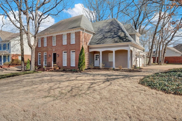 view of front of home featuring a garage, driveway, and brick siding