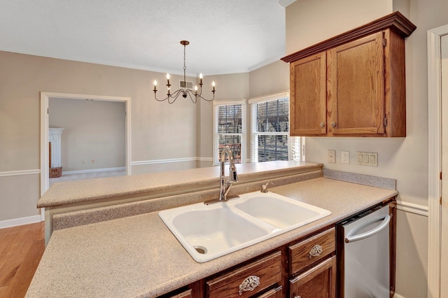 kitchen featuring light countertops, visible vents, stainless steel dishwasher, brown cabinetry, and a sink