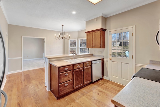 kitchen with light wood finished floors, stainless steel dishwasher, brown cabinetry, and a sink