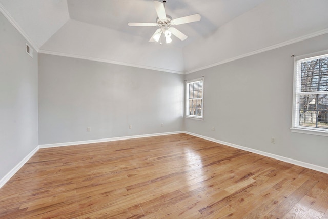 empty room with visible vents, crown molding, light wood finished floors, and ceiling fan