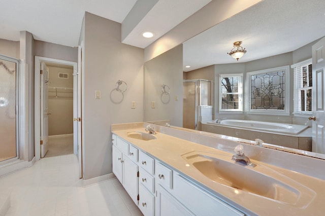 full bathroom featuring double vanity, a stall shower, visible vents, and a sink