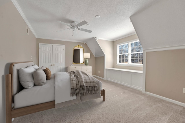 bedroom featuring baseboards, visible vents, ornamental molding, a textured ceiling, and carpet flooring