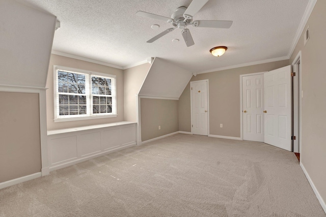 bonus room with a textured ceiling, carpet, a ceiling fan, and baseboards