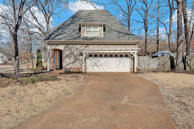 view of front of house featuring driveway, a gate, and fence