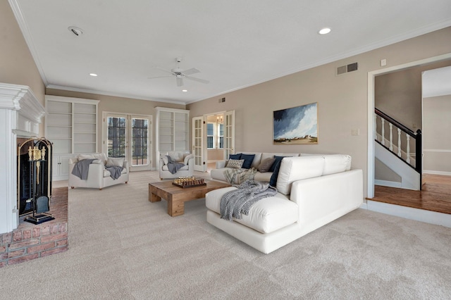 living area featuring recessed lighting, carpet floors, visible vents, stairway, and a brick fireplace