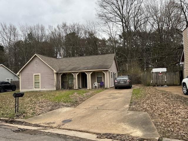 view of front of home featuring driveway and a porch