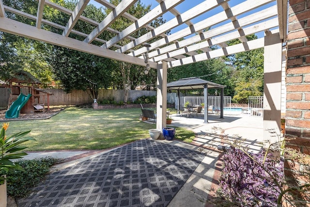 view of patio featuring a playground, a fenced backyard, and a pergola