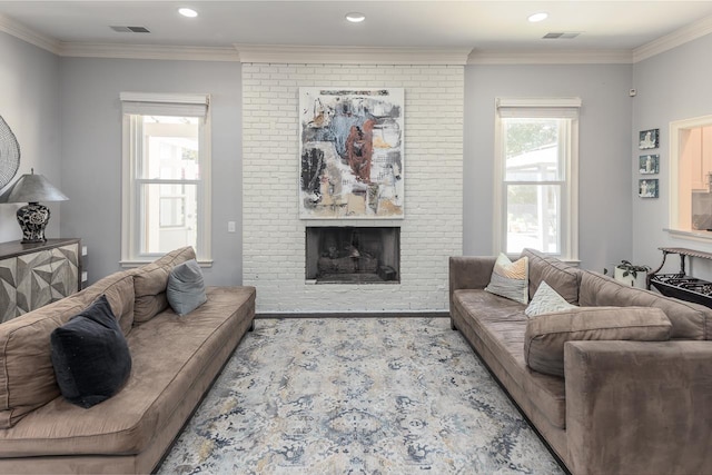 living room featuring a fireplace, visible vents, crown molding, and recessed lighting