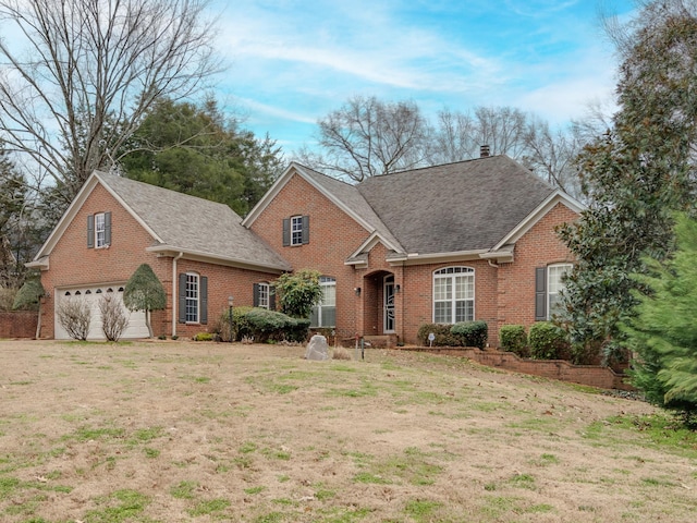 view of front of home with an attached garage, brick siding, roof with shingles, and a chimney