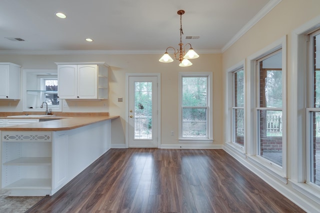 kitchen featuring dark wood-style flooring, visible vents, white cabinetry, light countertops, and open shelves