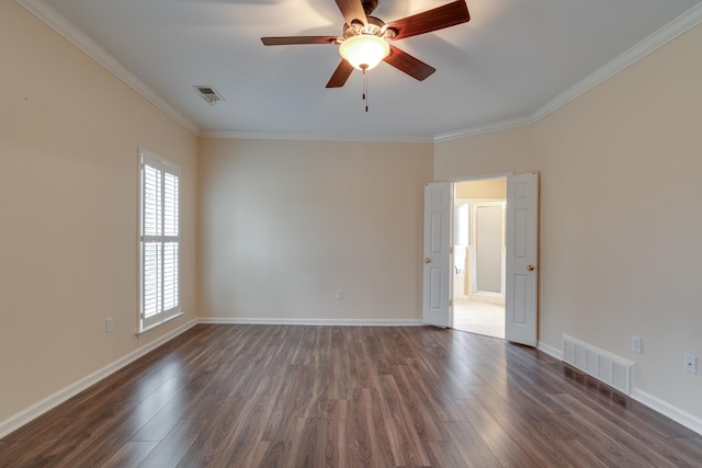 unfurnished room featuring ornamental molding, dark wood-style flooring, and visible vents