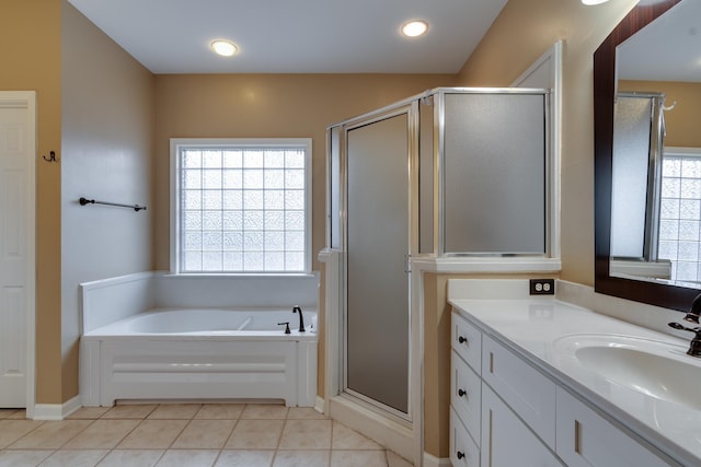 bathroom featuring tile patterned flooring, vanity, a bath, and a shower stall