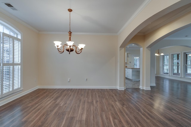 empty room with a chandelier, dark wood-type flooring, visible vents, baseboards, and ornamental molding