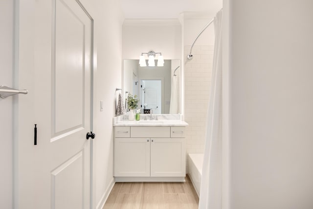 full bath with ornamental molding, shower / bathtub combination with curtain, and vanity