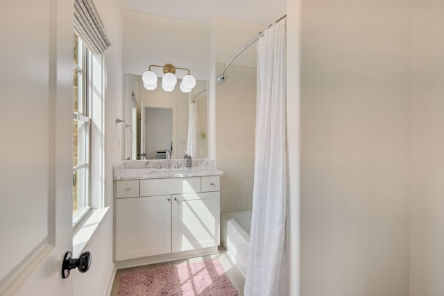 full bathroom featuring shower / bath combo with shower curtain and vanity