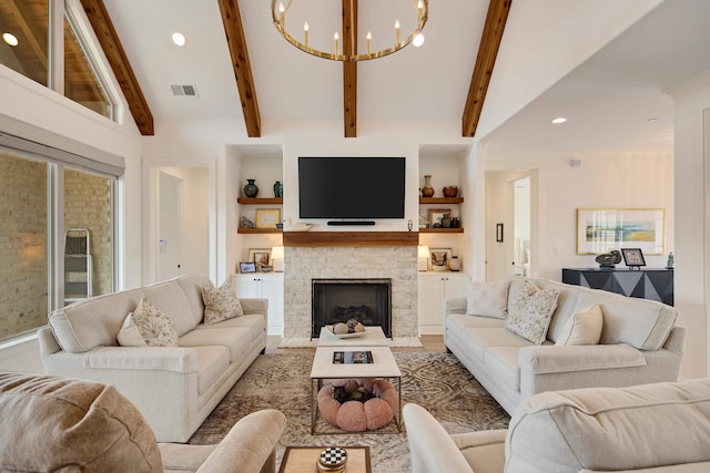 living area featuring built in features, a chandelier, visible vents, and a fireplace