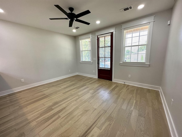 spare room featuring recessed lighting, visible vents, baseboards, and wood finished floors