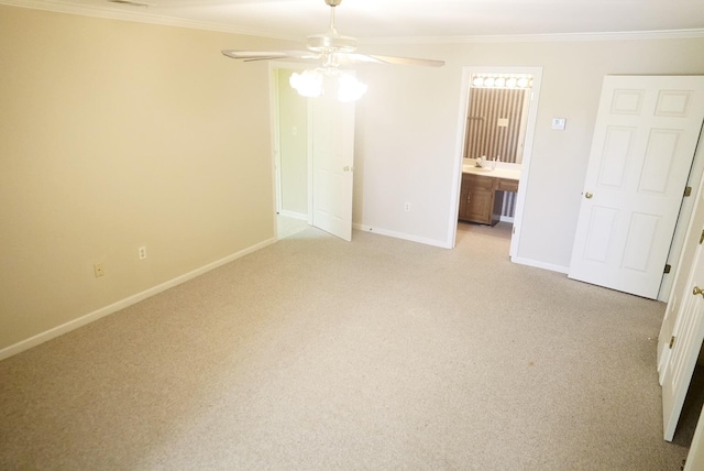 unfurnished bedroom with crown molding, light carpet, ceiling fan, ensuite bath, and baseboards